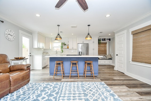 interior space featuring light hardwood / wood-style floors, ceiling fan, crown molding, and sink