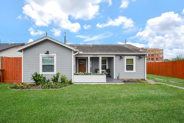 back of property featuring a lawn