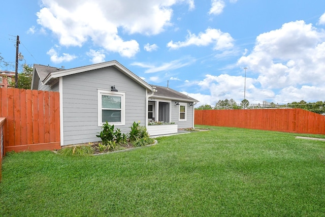 back of property featuring a lawn