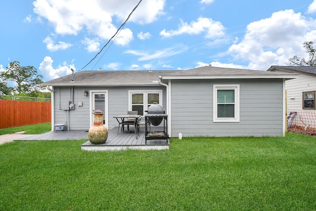 back of property featuring a yard and a deck