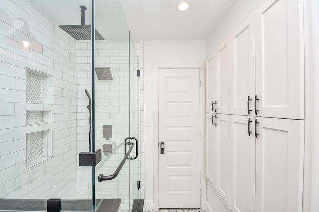 bathroom featuring a shower with door