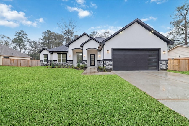 view of front of property featuring a garage and a front yard