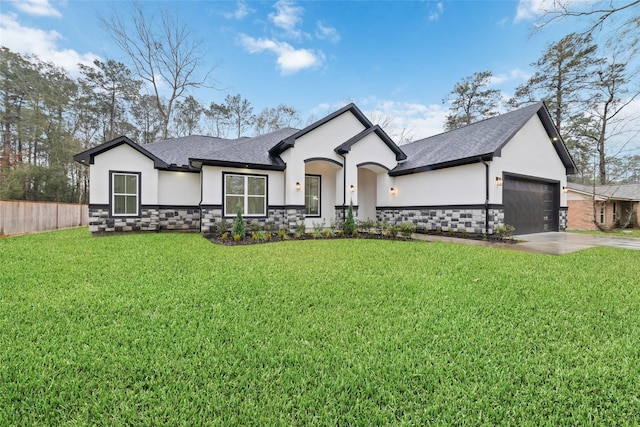 view of front of property featuring a garage and a front lawn