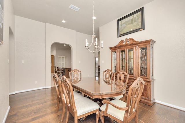 dining room featuring dark hardwood / wood-style flooring and a notable chandelier