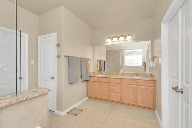 bathroom featuring tile patterned flooring, vanity, and a shower with shower door