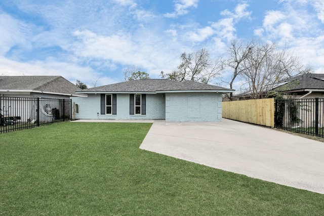 rear view of house featuring a lawn and a patio