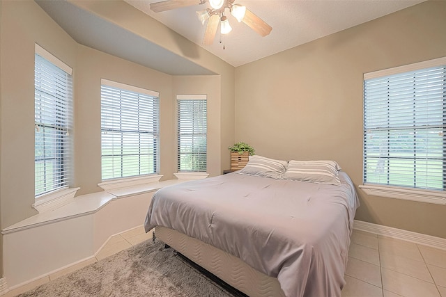 tiled bedroom with lofted ceiling and ceiling fan