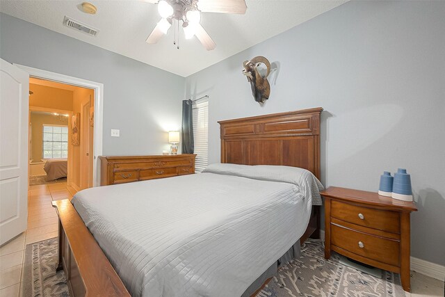 bedroom featuring tile patterned floors and ceiling fan