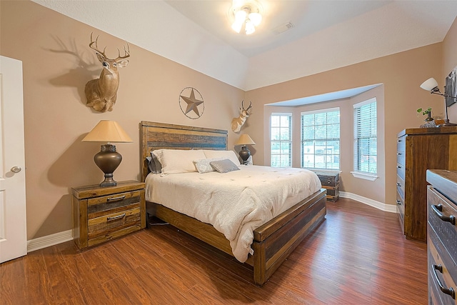 bedroom featuring vaulted ceiling and dark hardwood / wood-style floors