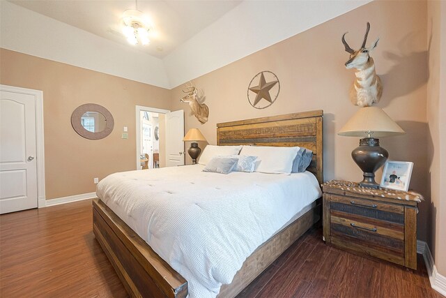 bedroom featuring lofted ceiling and dark wood-type flooring