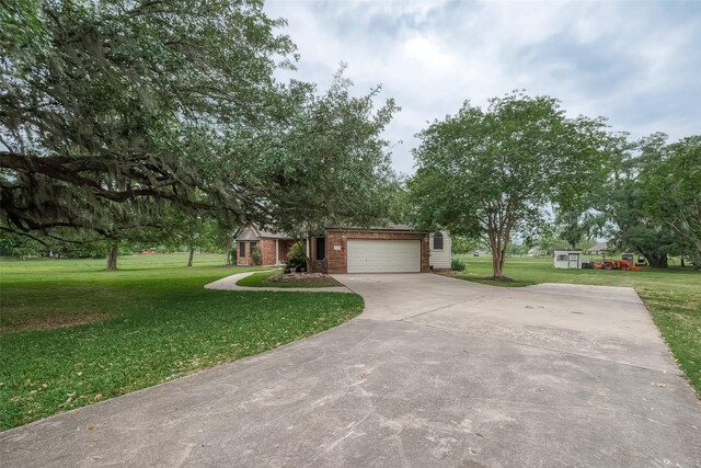 view of front of home with a garage and a front lawn