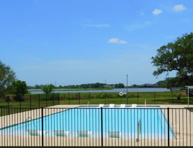 view of pool featuring a patio area and a water view