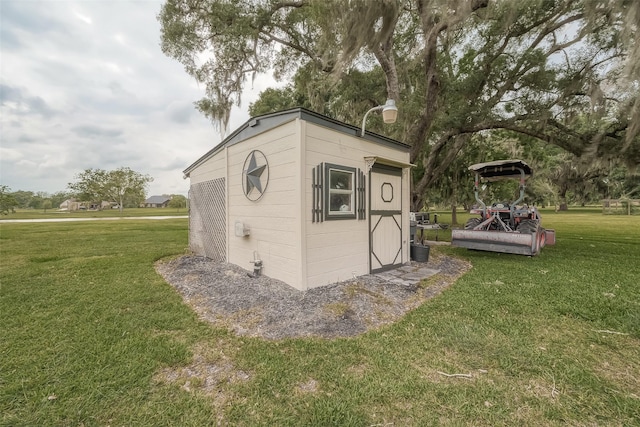 view of outbuilding with a yard