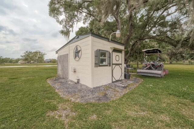 view of outbuilding with a yard