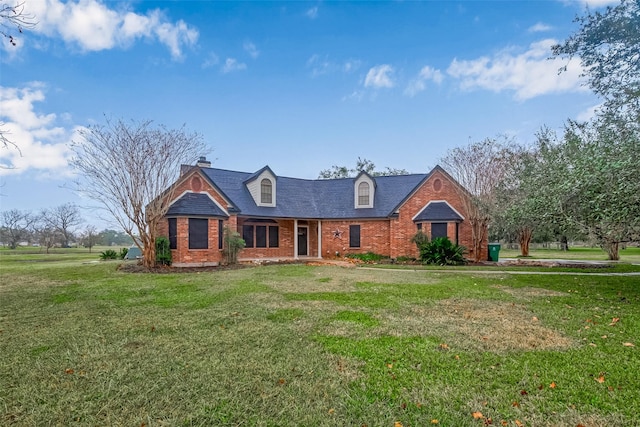 cape cod house with a front lawn