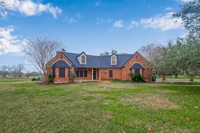 cape cod house with a front lawn