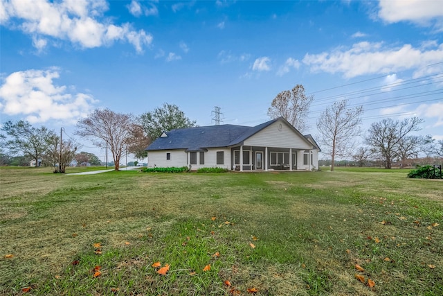 exterior space with a lawn and a sunroom