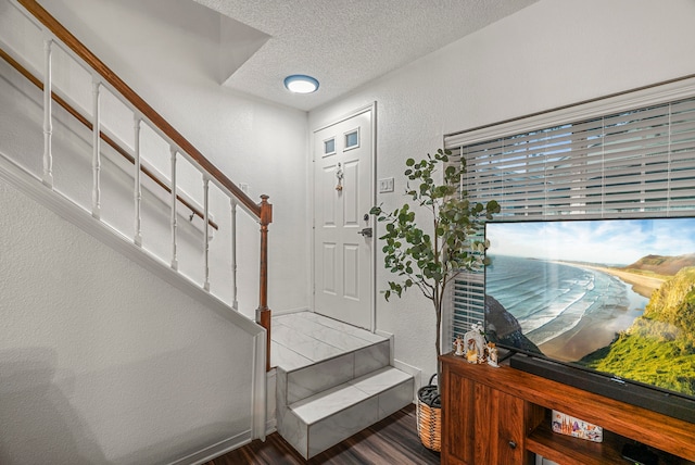 entryway featuring a textured ceiling and hardwood / wood-style flooring