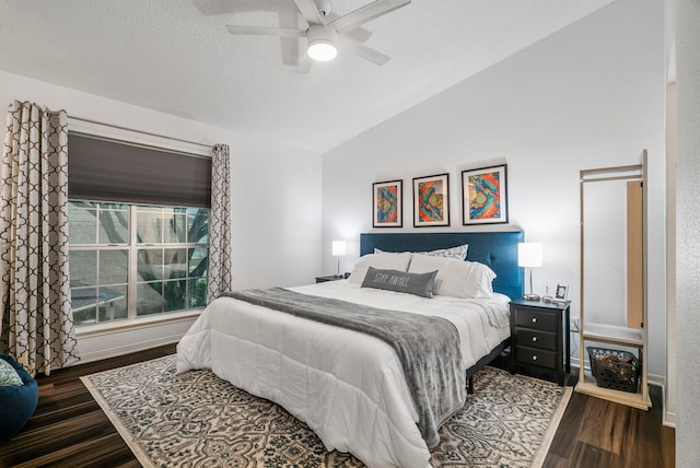 bedroom with a textured ceiling, ceiling fan, dark hardwood / wood-style flooring, and lofted ceiling