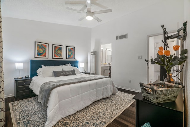 bedroom featuring a textured ceiling, ensuite bathroom, ceiling fan, and dark wood-type flooring