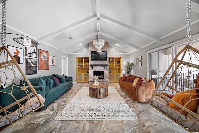 living room with vaulted ceiling with beams, a fireplace, and a chandelier