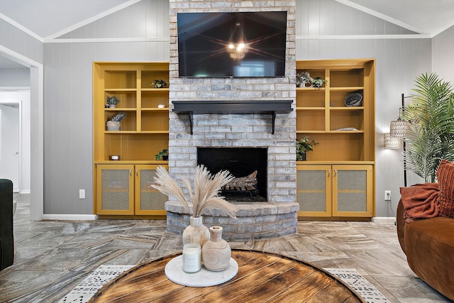 living room with lofted ceiling, built in features, ornamental molding, and a fireplace