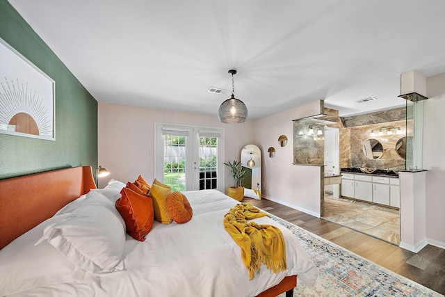 bedroom with access to exterior, wood-type flooring, and french doors