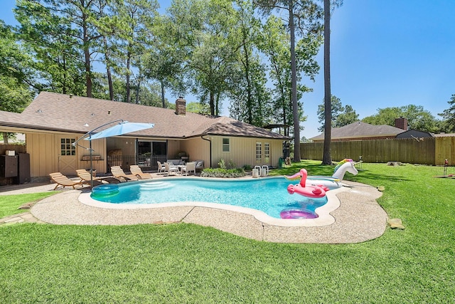 view of swimming pool featuring a lawn and a patio area