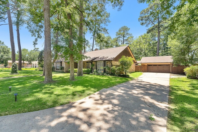 ranch-style home featuring a garage, an outdoor structure, and a front lawn