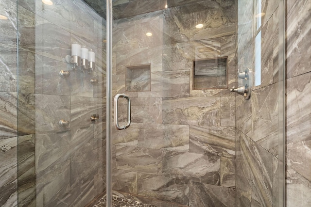 bathroom with a shower with door