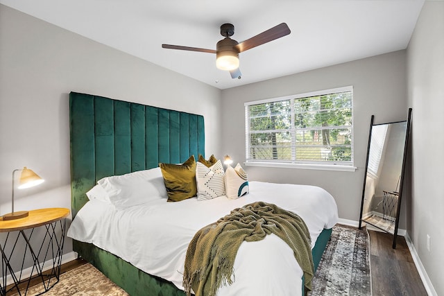 bedroom featuring ceiling fan and dark wood-type flooring