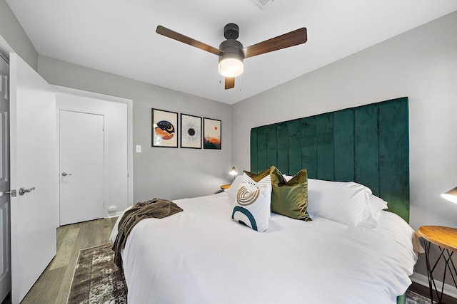 bedroom with hardwood / wood-style flooring and ceiling fan