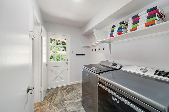 clothes washing area featuring independent washer and dryer