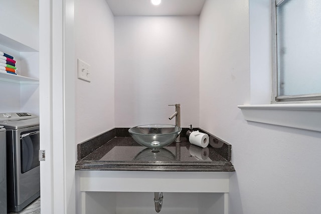 bathroom with washing machine and clothes dryer and vanity