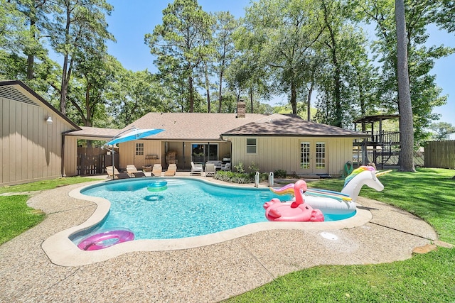 view of pool featuring a patio area, a yard, and french doors