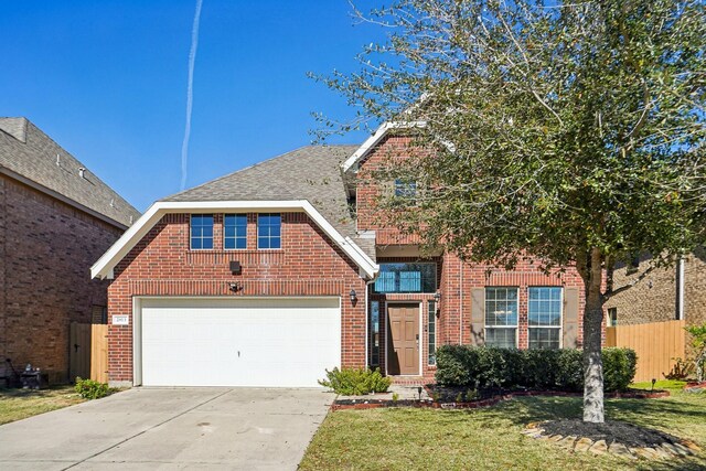 front of property featuring a garage and a front lawn