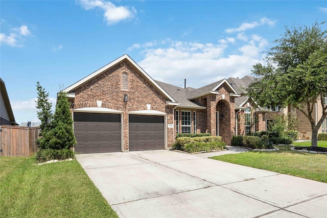 view of front of house with a garage and a front yard