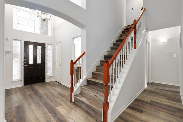 foyer with dark wood-type flooring and a high ceiling