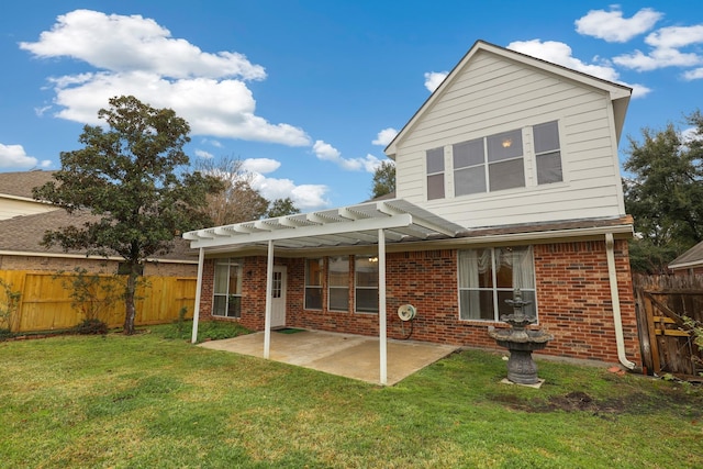 rear view of house with a pergola, a yard, and a patio