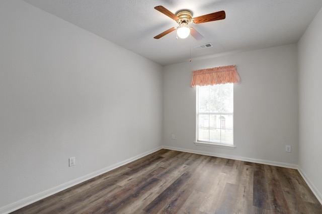 spare room featuring ceiling fan and dark hardwood / wood-style flooring