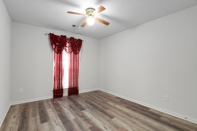 spare room featuring hardwood / wood-style flooring and ceiling fan