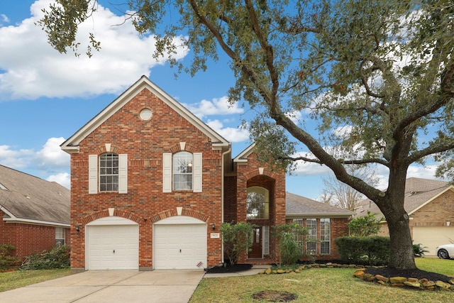 view of property featuring a garage and a front lawn