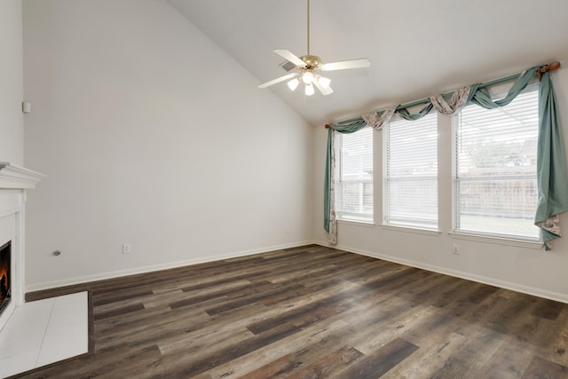 unfurnished living room with ceiling fan, dark hardwood / wood-style flooring, high vaulted ceiling, and a healthy amount of sunlight