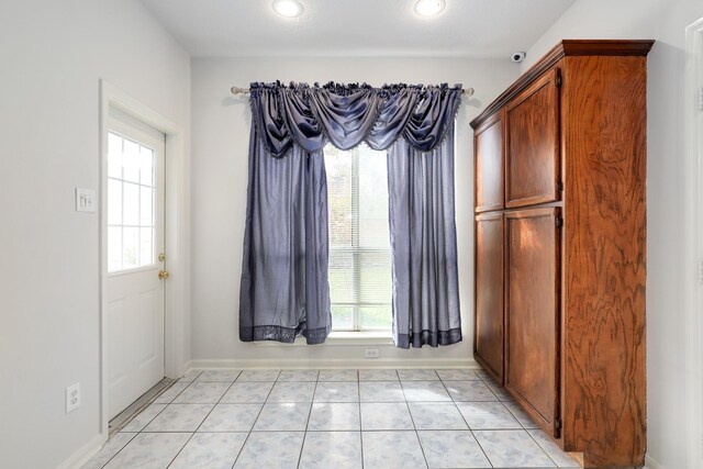 interior space with a wealth of natural light and light tile patterned flooring