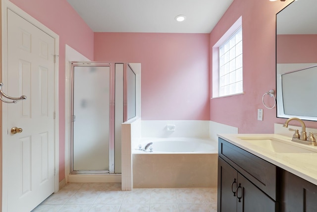 bathroom with tile patterned flooring, shower with separate bathtub, and vanity