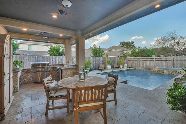 view of swimming pool featuring an outdoor kitchen, a patio, ceiling fan, and grilling area