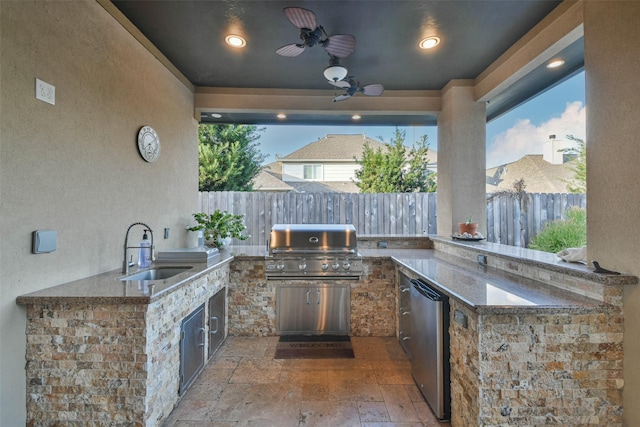 view of patio with grilling area, ceiling fan, sink, and an outdoor kitchen