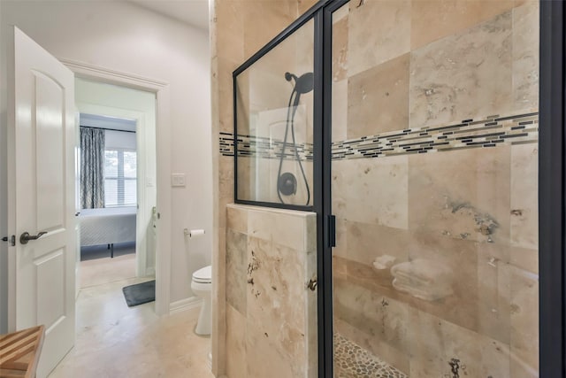 bathroom featuring toilet and an enclosed shower