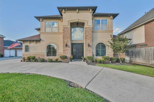 view of front of house with a front yard and french doors