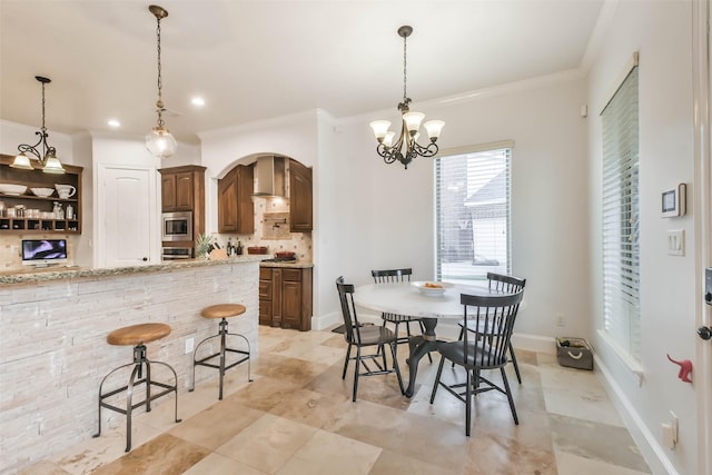 dining room featuring an inviting chandelier and crown molding